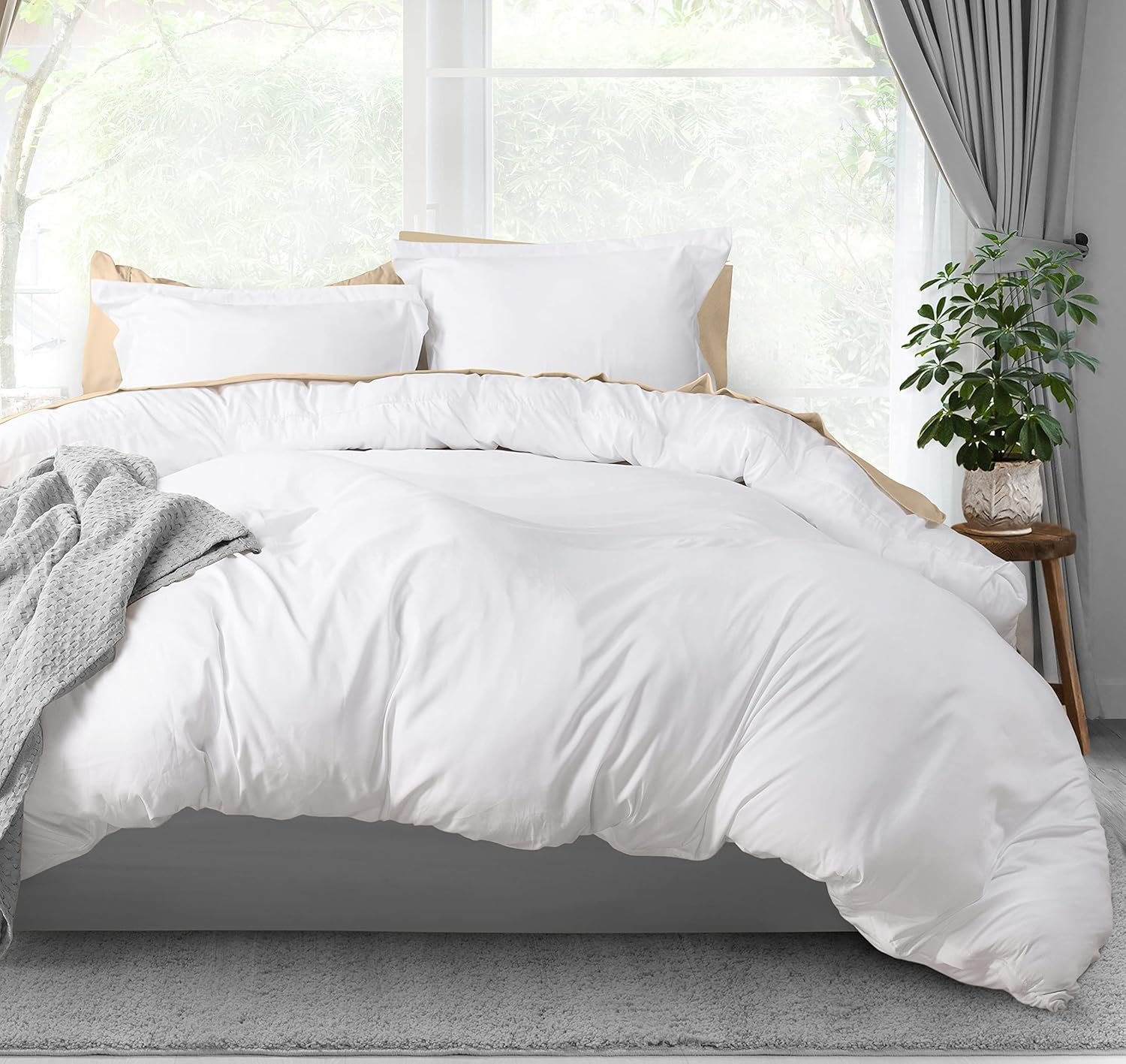 "White duvet cover neatly spread out on a bed, featuring a crisp and clean appearance. The fabric appears smooth and soft, with a simple, classic design."