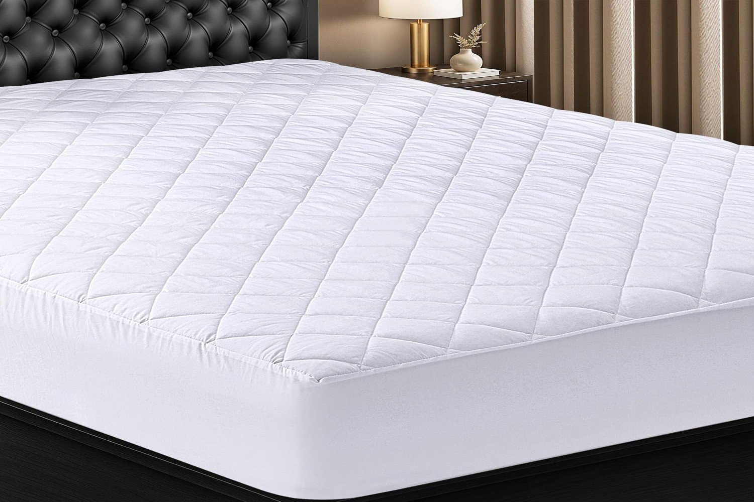 "White mattress with a smooth, clean surface and a simple, classic design. The mattress is positioned on a neutral-colored bed frame and is surrounded by a minimalistic bedroom setting."